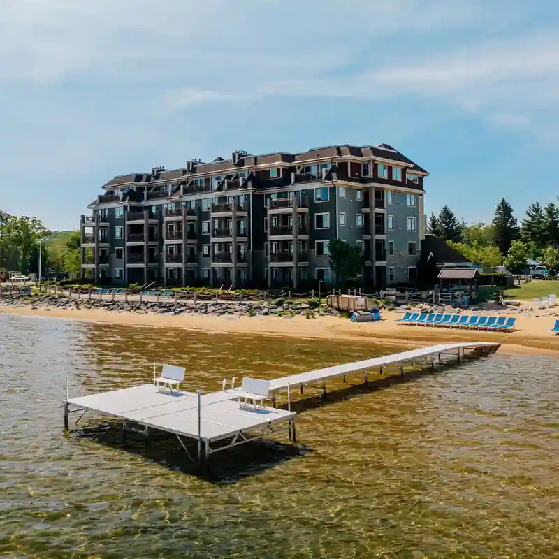 Dark-clad condominium building beside a dock