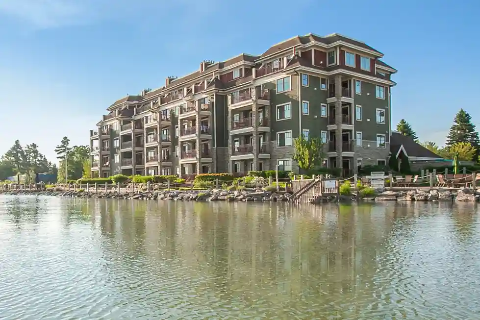 Dark-clad condominium building seen from the water