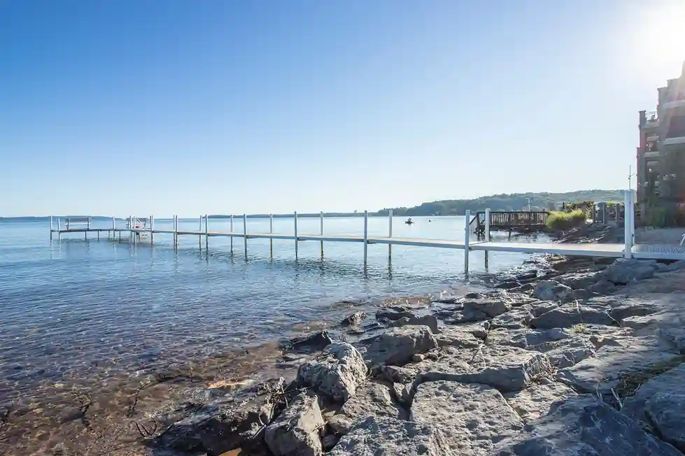Rocky shoreline and a dock on East Grand Traverse Bay