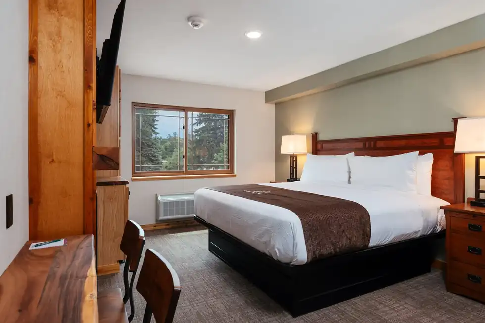 King room with a window onto the trees on the city side of the lodge