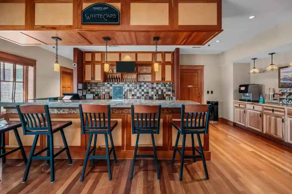 Beverage bar with stools under a timber soffit