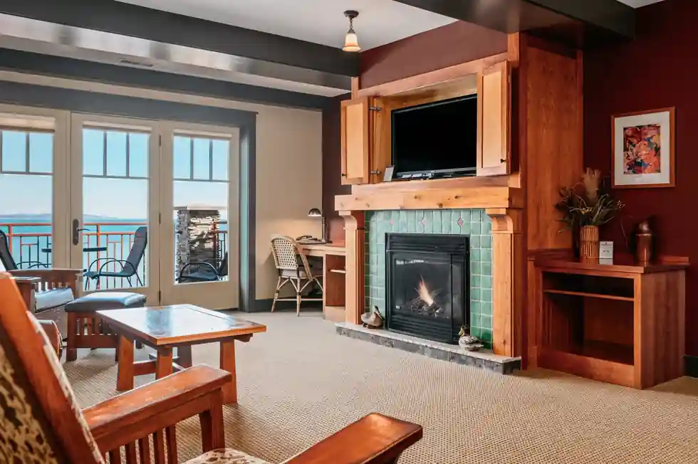Living area with a tiled fireplace and balcony doors