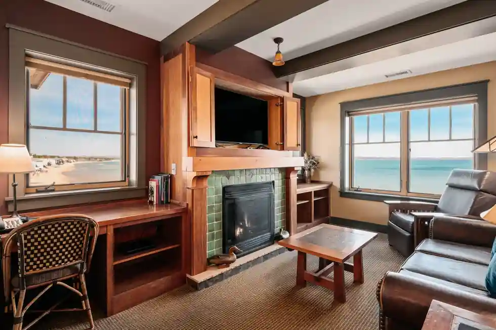 Suite living room with a tiled fireplace and a picture window onto the bay