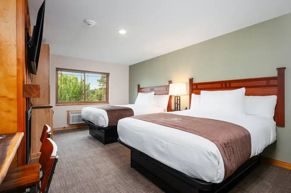 Two queen beds side by side in a hotel room
