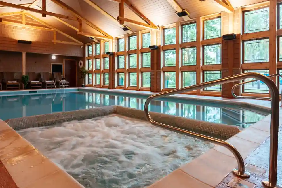 Indoor pool and bubbling hot tub under the timber roof of the Cedar Cottage wing